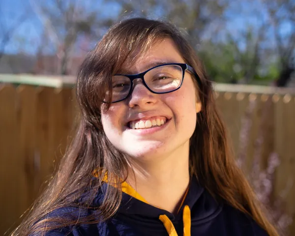 Example of mixed light sources. Camera is set for daylight, but a warm orange fill light is coming from the side. The subject's skin looks unnatural.