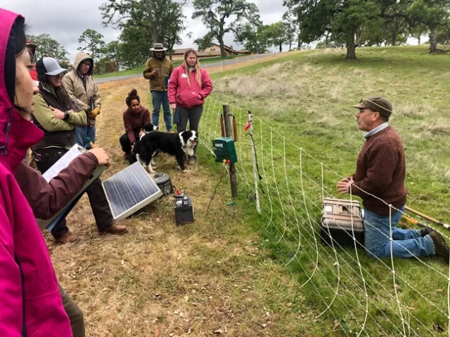 Macon, right, speaks to participants in the March 7, 2020, lambing school by Kaleiah Schiller