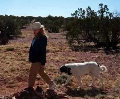 Meredith Hergenrader on her 40-acre farm with family pet, Odin.