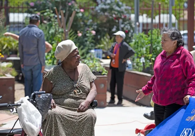 Senior ambassadors, like the woman in red, encourage neighbors to join activities like this 2018 class on growing food in gardening containers.