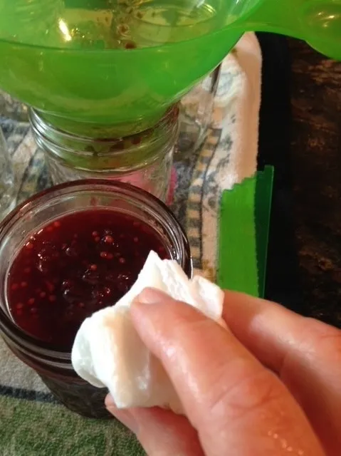 Wiping jar rim with damp towel