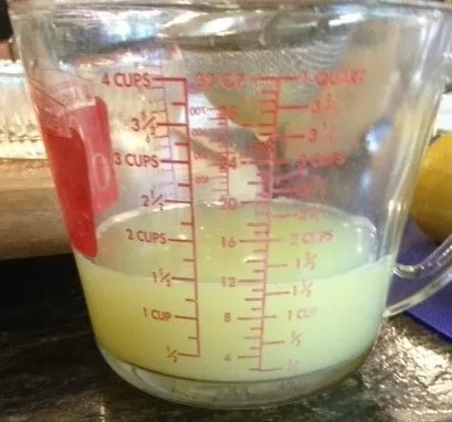 Fresh squeezed lemon juice in a measuring cup