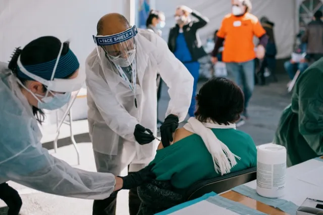 President Drake vaccinates an individual in the Bay Area's Mission District.