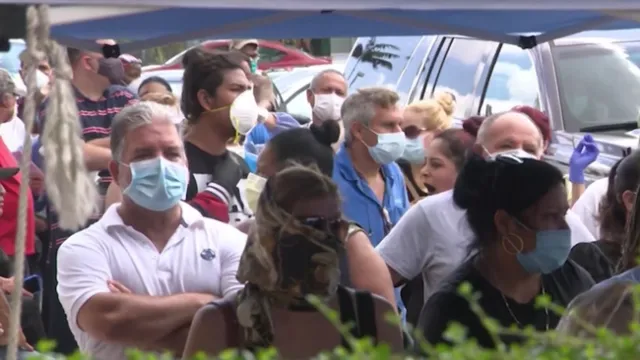 larga fila de personas en busca de los beneficios del desempleo