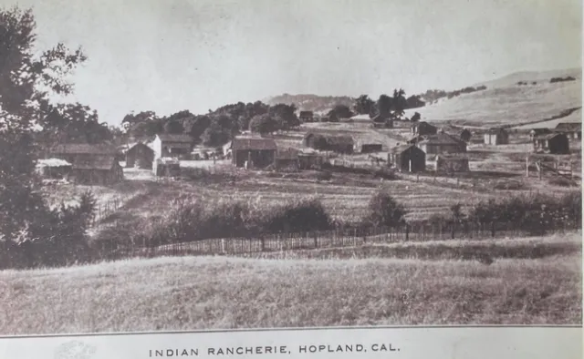 Sepia-tone image of one-story structures.