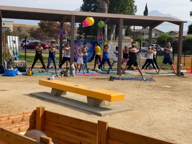 Community members enjoy a yoga and mindfulness class in the Seeds of Joy garden