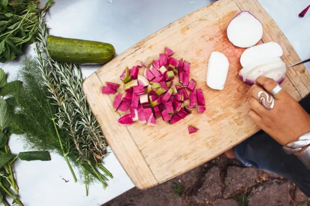 Vegetables being sliced up on a cutting board