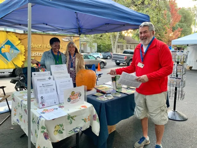 Marie Dillon, Cynthia Finnegan and Chris Young (from left) working the MG booth at Chico Farmers Market, Laura Kling