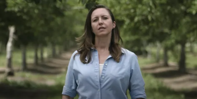 Close up of Kat with the Hrdys' walnut orchard in background