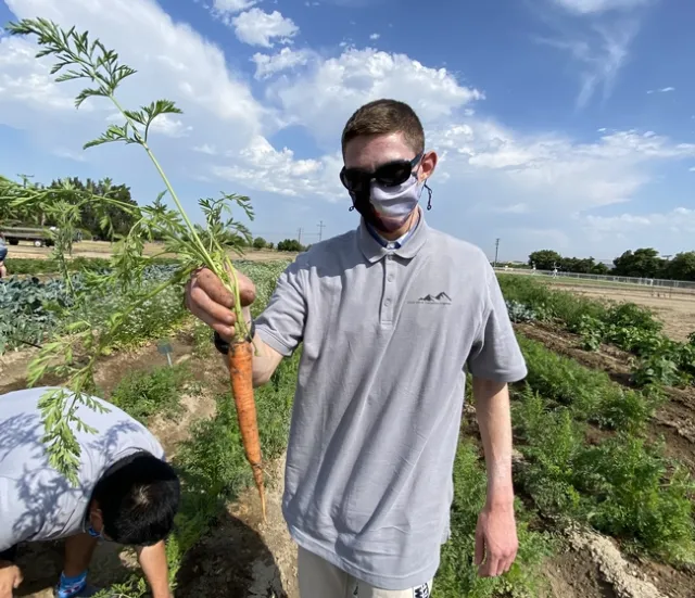 Student holding a carrot at South Coast REC