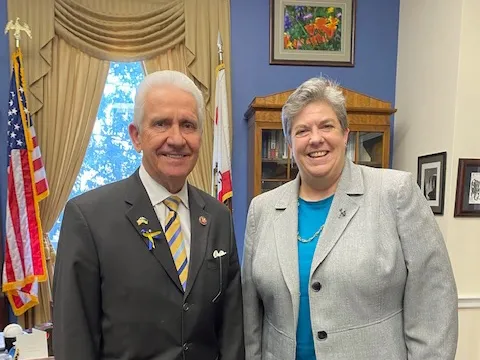 Jim Costa, left, poses beside Glenda Humiston in his office. A U.S. flag hangs behind his shoulder.