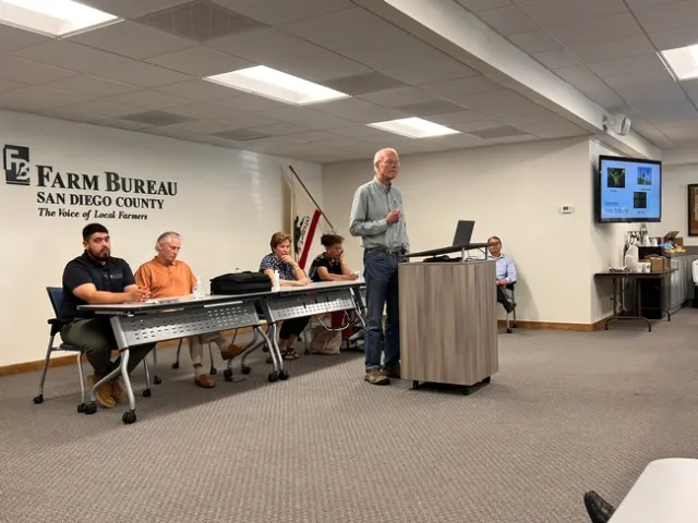 A man giving a presentation while standing behind a podium.