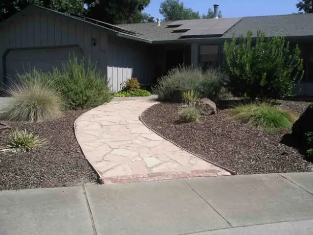 A house absorbs heat during the day and re-radiates it at night; paved surfaces like this flagstone pathway also absorb and re-radiate the sun's energy, Cindy Weiner