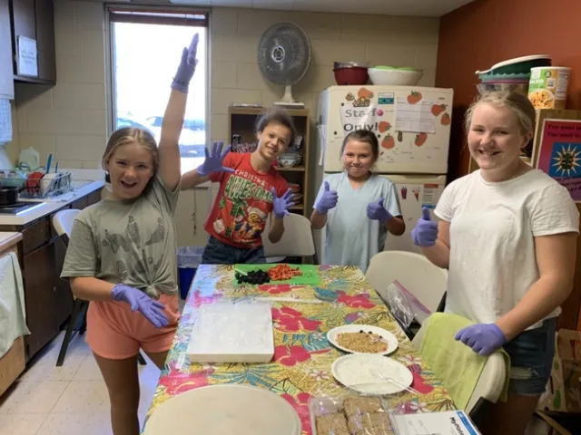 Young people cooking in the kitchen at Foothill Indian Education Alliance's center in Placerville