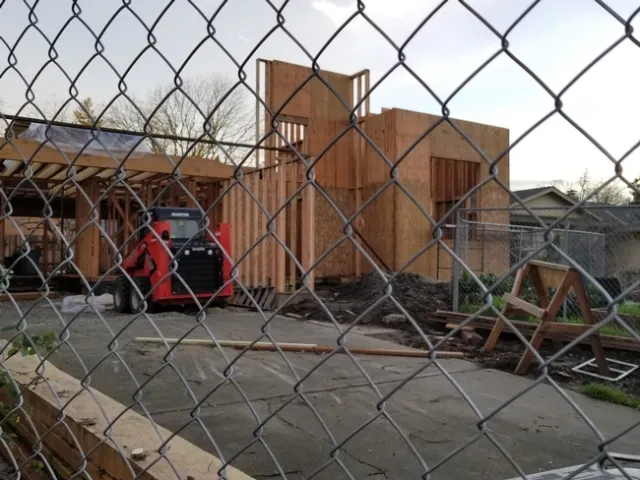 House undergoing remodeling. The construction is down to the two by fours and ply board on the new addition.
