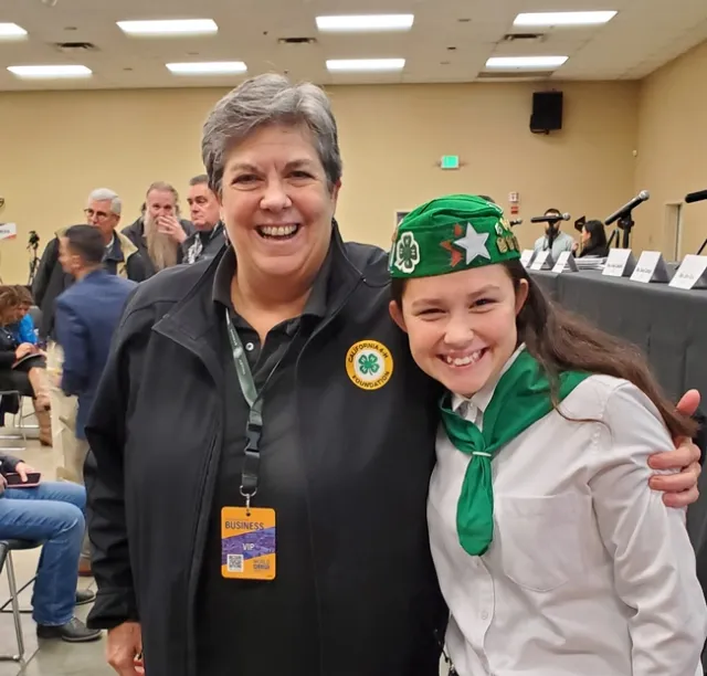 Humiston is wearing a black jacket with a California 4-H Foundation emblem. Kambree is wearing her green and white 4-H uniform.