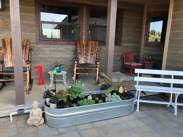 Shade-loving plants add color underneath a covered porch. Debi Durham