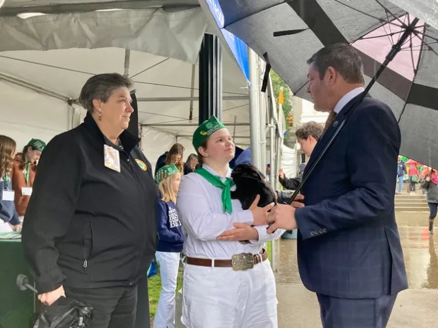 Glenda Humiston looks on as 4-Her Emily speaks with Assemblymember Jim Wood.