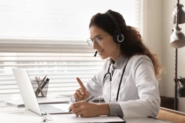A doctor consults over a laptop