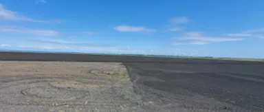 Fallow field where soil was tilled during the 2021 summer (unworked area to the left where soil is a light brown) or during the 2022 spring (rolled area to the right where soil is a dark brown).