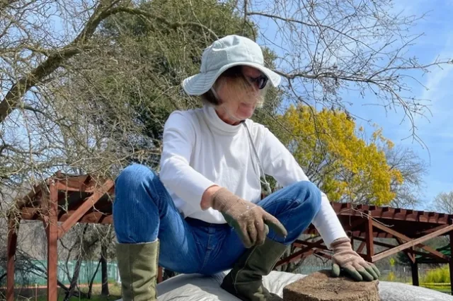 Pat Decker standing on a pile of compost