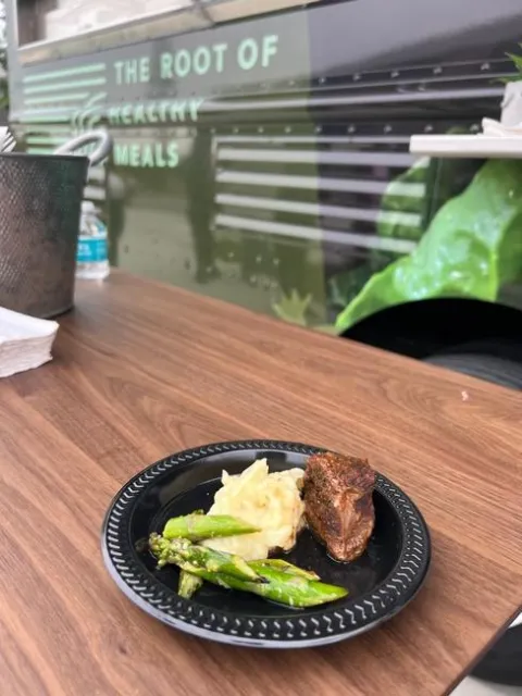 A plate of food with a sign in background reading: 