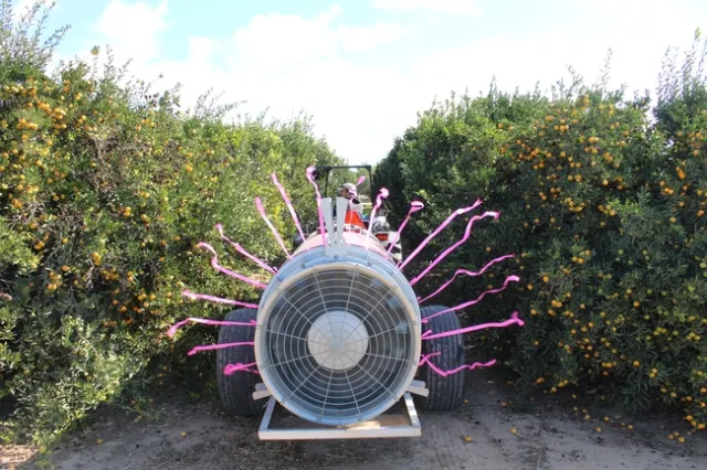 Staff research associate Ryan Puckett operating sprayer for demonstration.