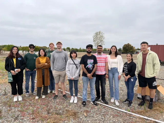 A group of college students gather and pose for a photo.