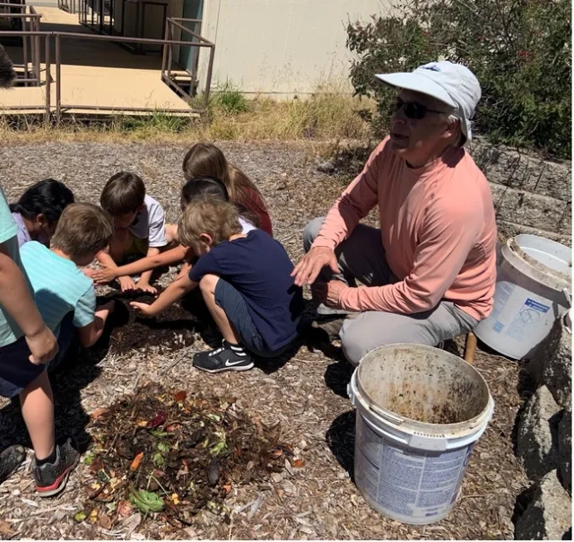 Children playing with soil made from compost.