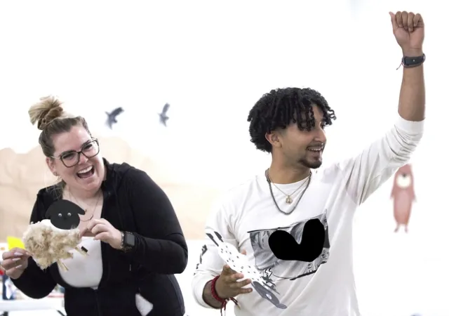 Two people share a laugh during day camp