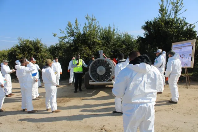 Postdoctoral scholar Dr. Abiodun Abioye speaking about sprayer equipment parts