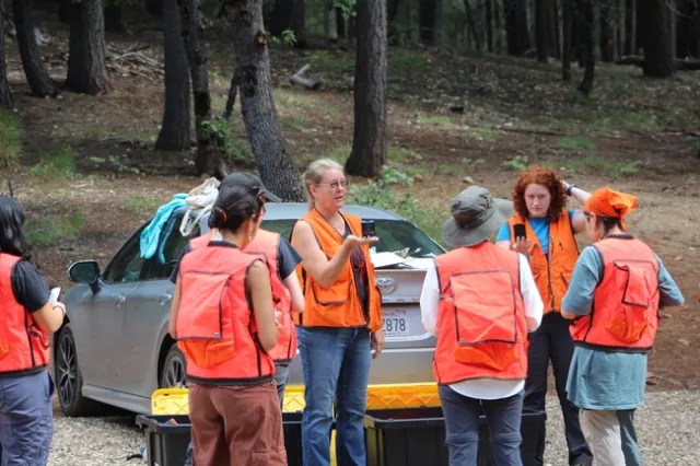 Kocher and Reidy illustrate how to use a compass during Mini-Camp's ‘Forestry Skills' demonstration. Photo credit: Karina Bencomo.
