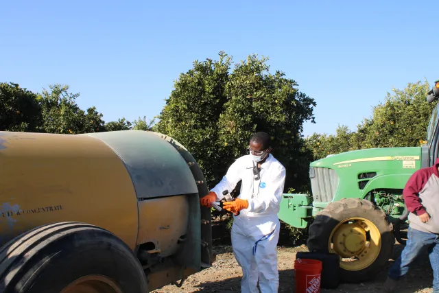 Peter Larbi measuring nozzle output for airblast calibration.
