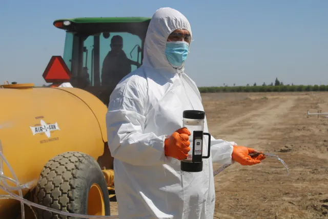 Daniel Cabrera measures nozzle output with digital volumetric device.
