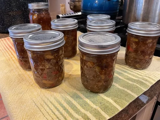 Processed jars resting on towel on counter