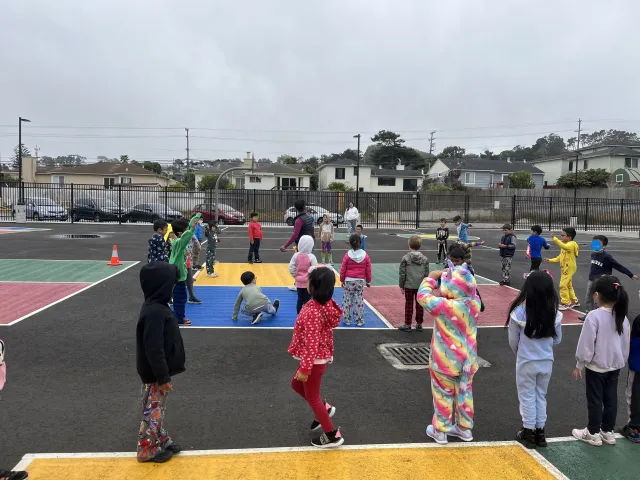 Community Nutrition Educator leading physical activity lesson with afterschool program