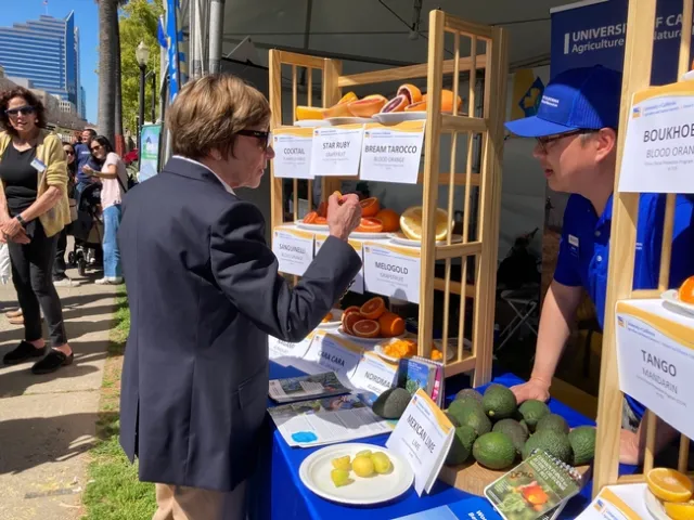 Karen Ross, CDFA secretary, discussed kumquats with Mike Hsu.