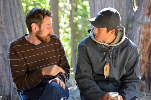 Adult Volunteer chatting with a youth in the On The Wild Side 4-H program.