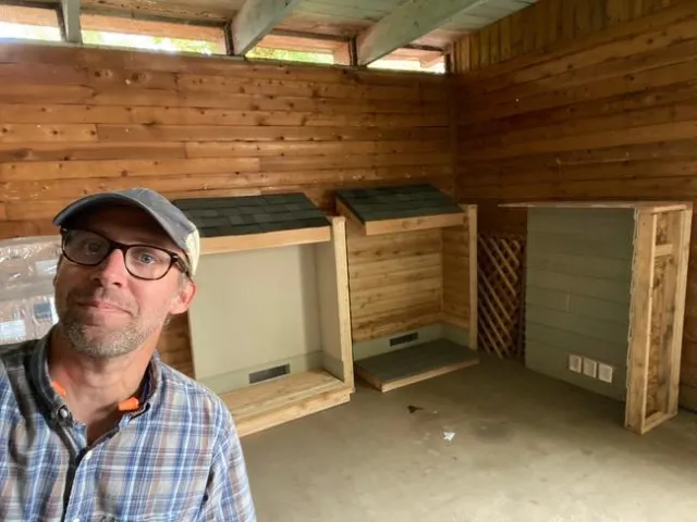 Ryan poses beside the three styles of walls.