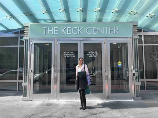 Eve at doorway to the Keck Center