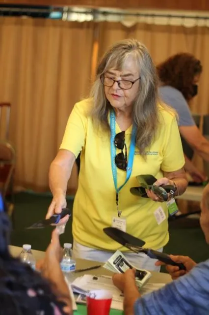 Ana Peeks, UC Master Gardener of Orange County, gives participants trowels for their home gardens.