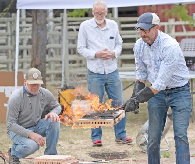 Ryan Tompkins, right, demonstrates wildfire risks. He will be posthumously honored by the state Board of ForestryNov. 6.