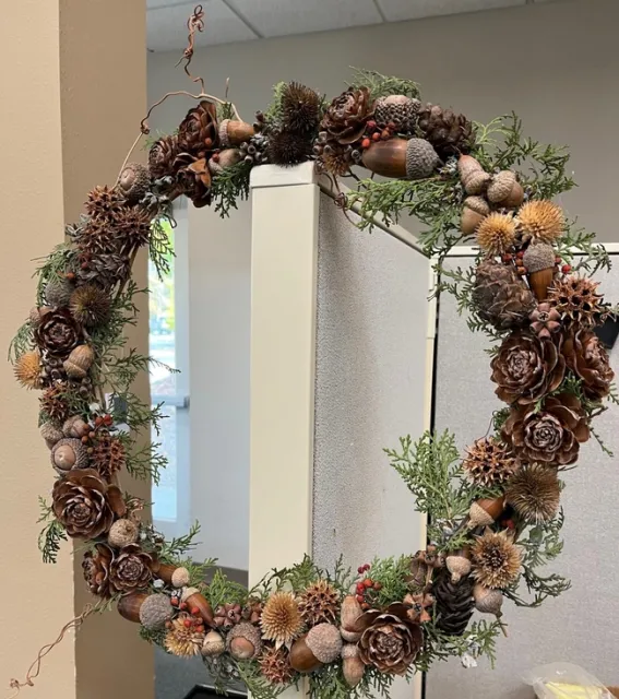 wreath made with grapevines, decorated with pinecones.