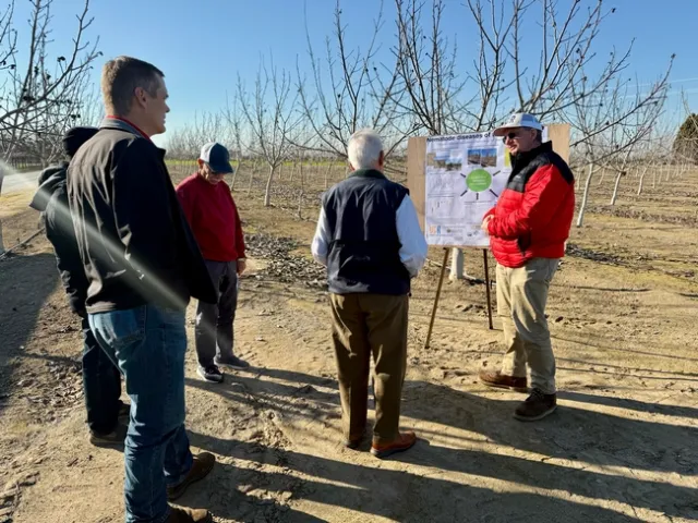 On a tour of Kearney REC, Andreas Westphal, wearing a hat and red and black jacket, explained his research on nematode control in various crops.