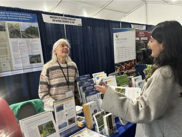 Sonja Brodt of UC SAREP, left, discusses sustainable agriculture with an enthusiastic student.