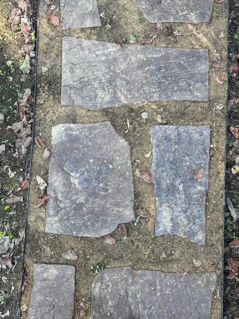 In this natural-looking path, flagstones are surrounded by decomposed granite and bordered by metal strips. J.C. Lawrence