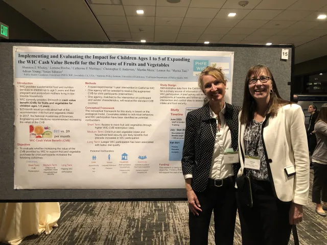 Shannon Whaley (left) with Lorrene Ritchie in front a research poster