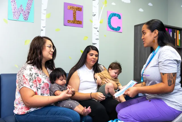Mothers bring their babies to a WIC nutrition education session
