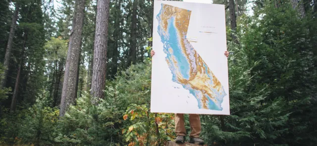 Person holding map of California.