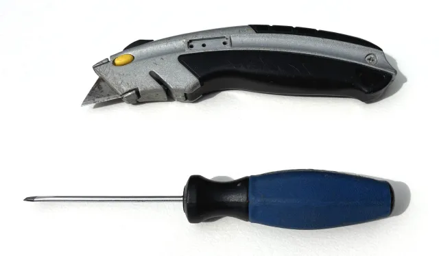 A screwdriver and a utility knife